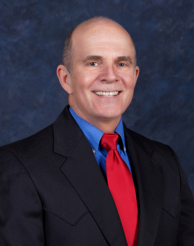 Headshot of Steve Starnes in black suit with a red tie.