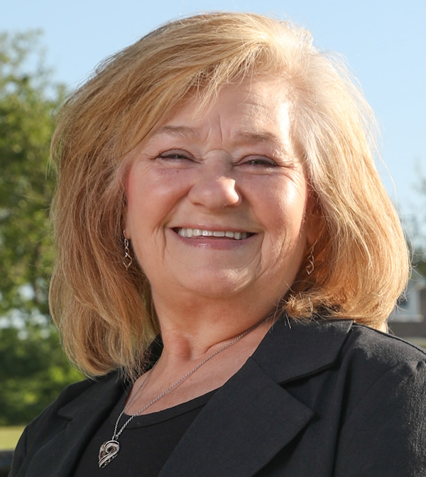 Headshot of Anita Fangman, a white female with mid-length blonde hair; she wears a pink shirt.